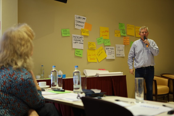 Philippe Ombredanne in front of a wall filled with many large post-its with ideas to improve the ecosystem.