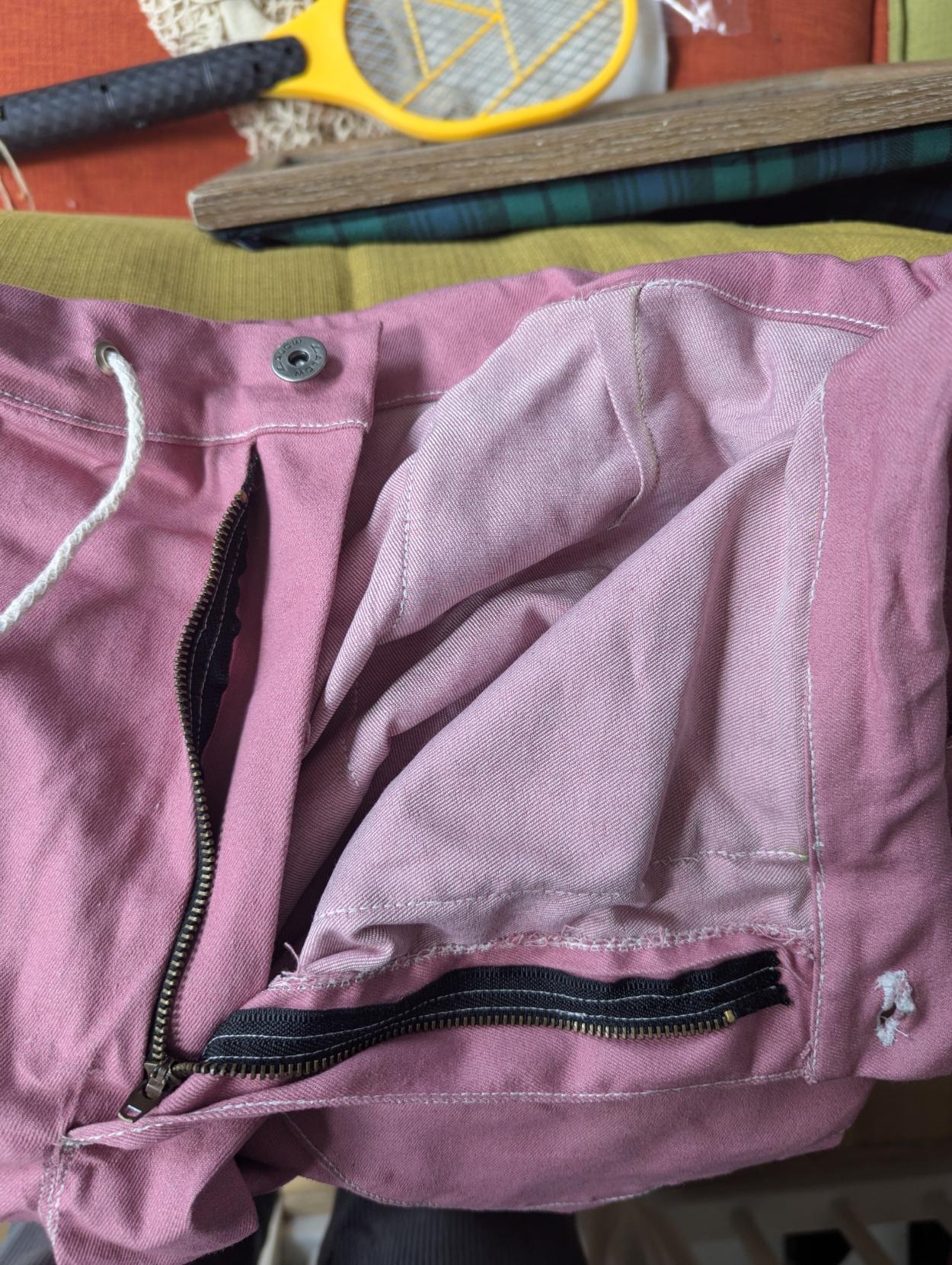 A close up of a pair of pink pants, the fly part